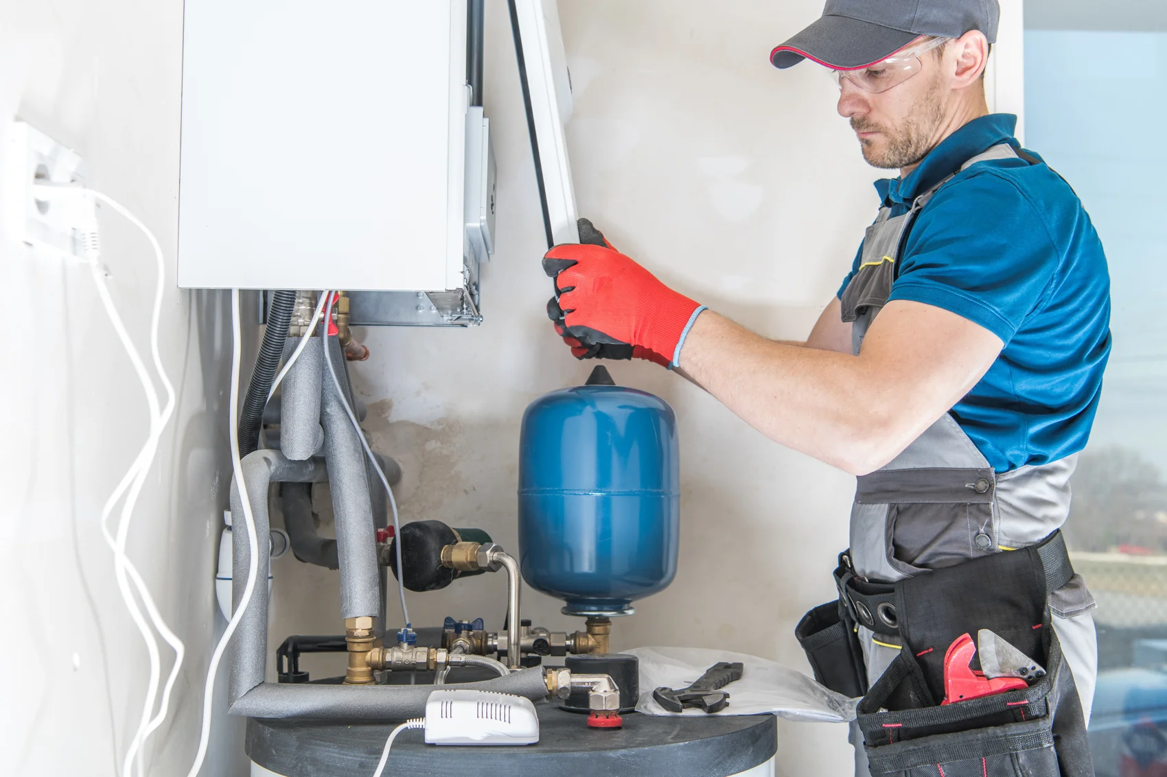 Technician installing a residential gas heating system
