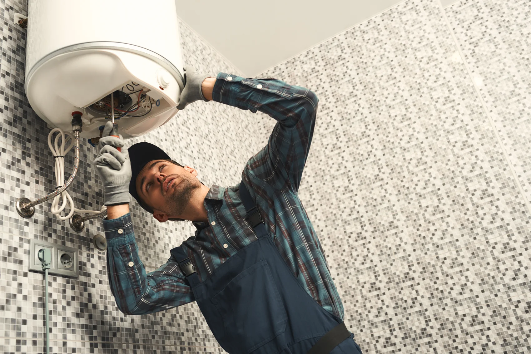 Plumber installing a high-efficiency tankless water heater in a Baltimore home