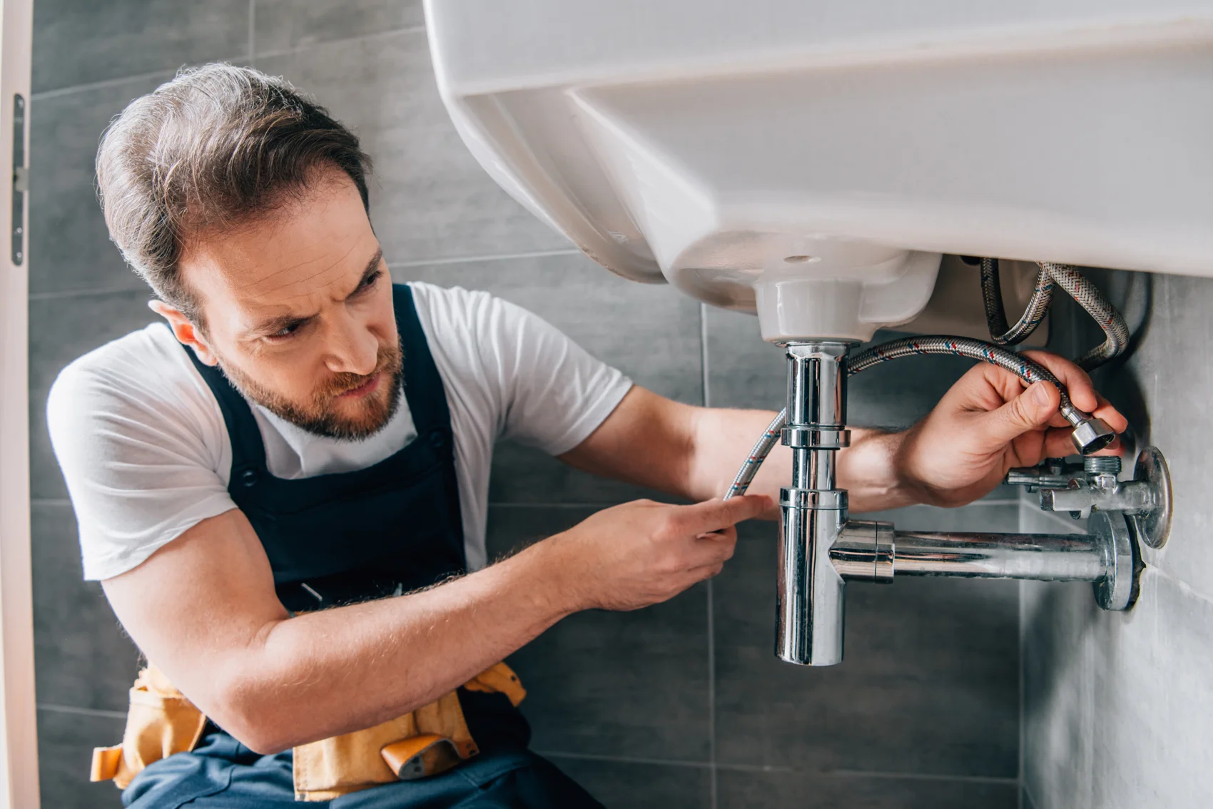 Saffer plumber working on a sink