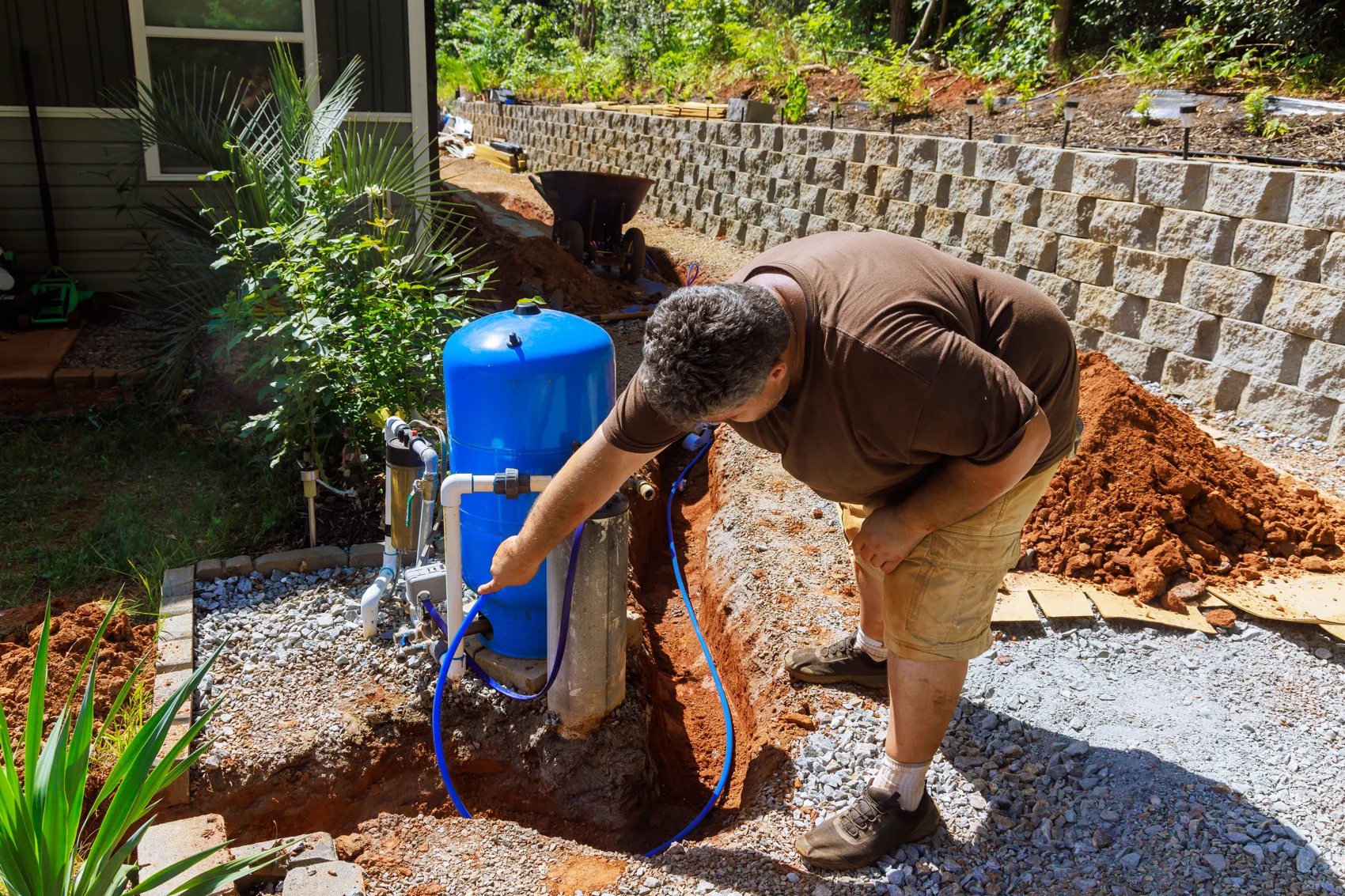 Technician installing an outdoor well water system