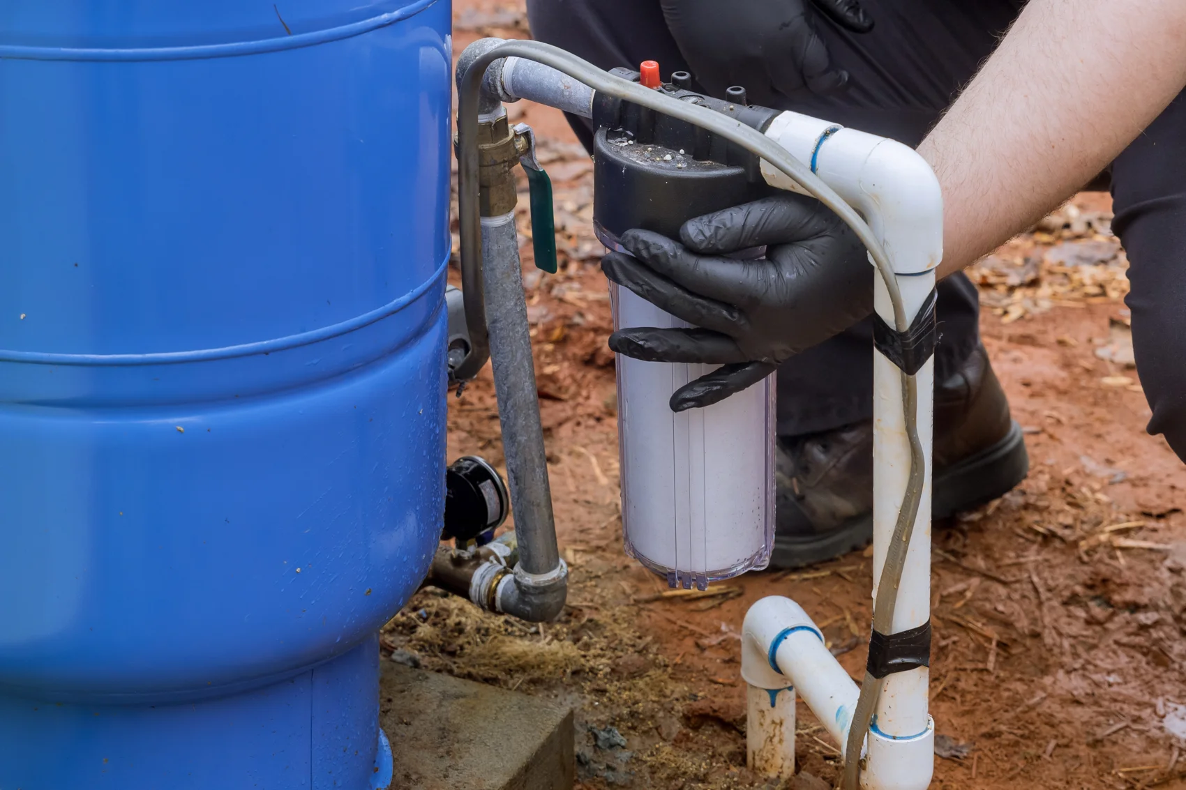 Technician installing a residential water filter system